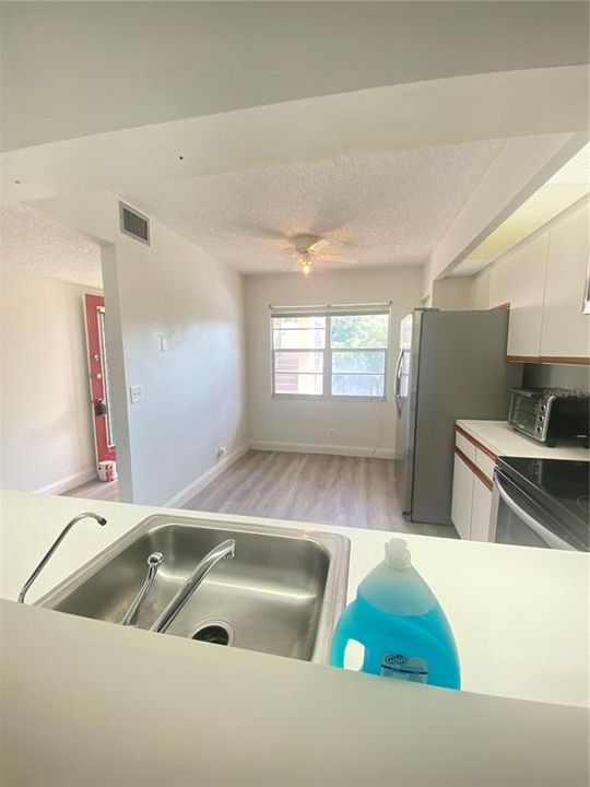 Eat in kitchen is equipped with stainless steel appliances, including a dishwasher