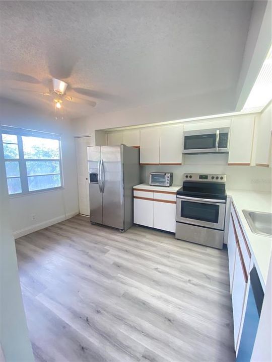 Eat in kitchen is equipped with stainless steel appliances, including a dishwasher
