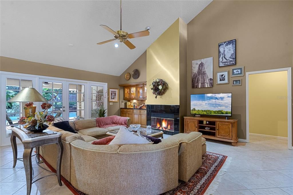 family room with wood-burning fireplace and a built-in dry bar