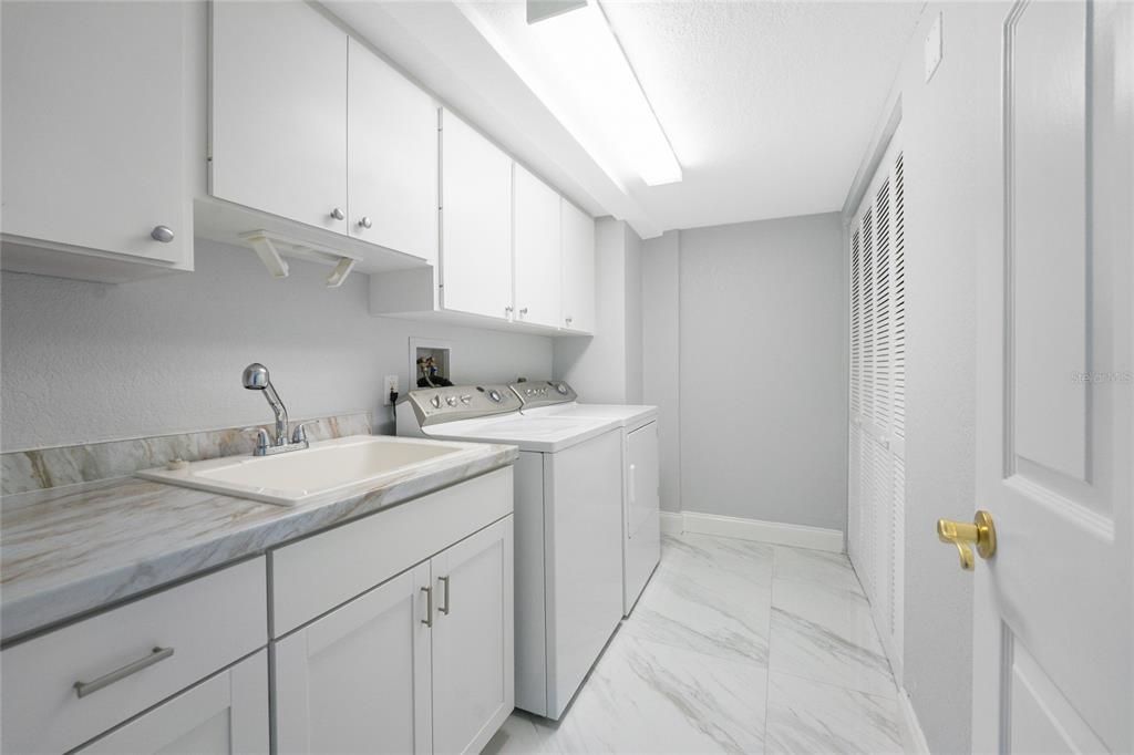 Spacious Laundry Room with new lower  cabinets, counter, sink and faucet