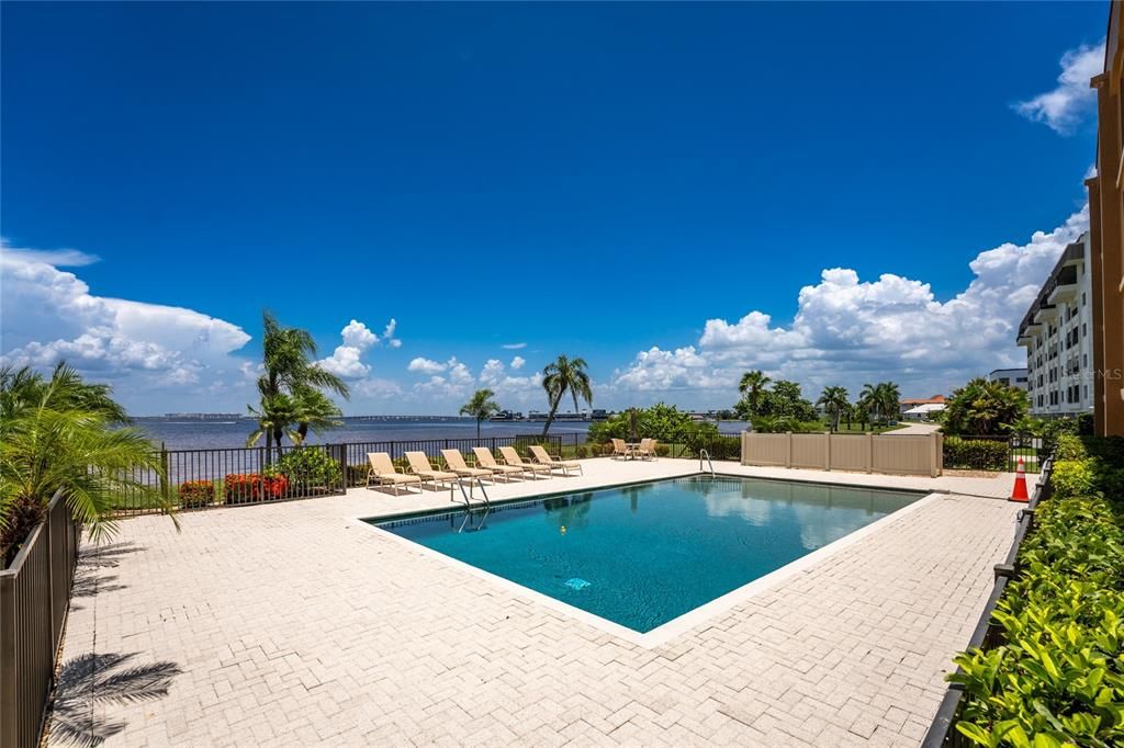 Beautiful white pavered pool deck with a large heated pool overlooks the Harbor!