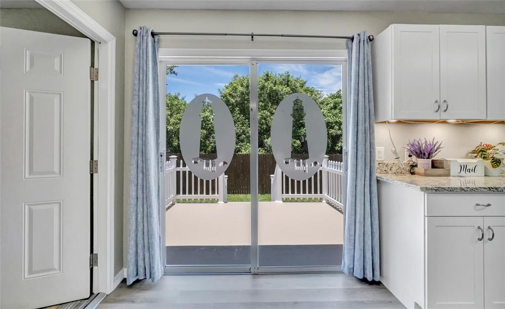 Sliders to the spacious elevated porch. Door to the laundry room and garage.