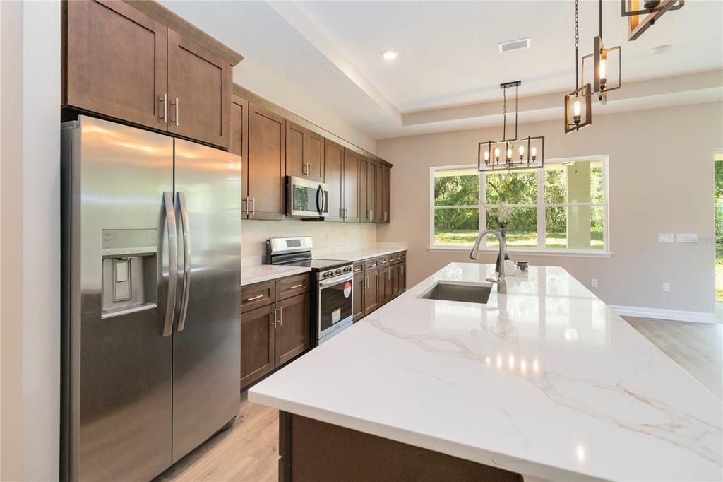 Custom Kitchen w/ quart countertops and tile backsplash