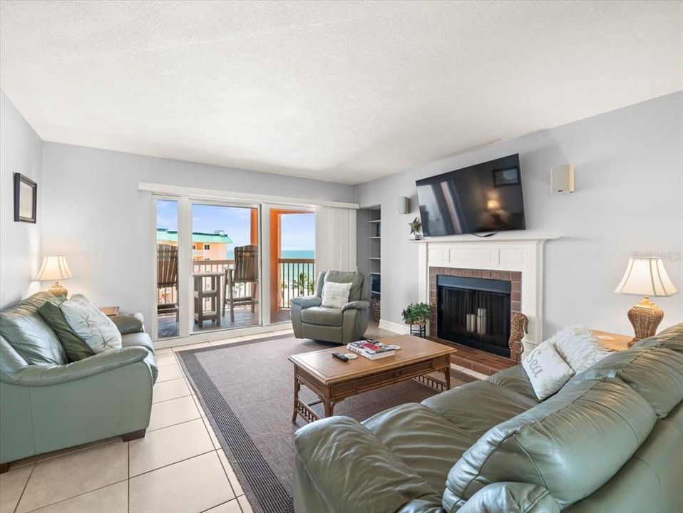 Living room with fireplace and balcony access