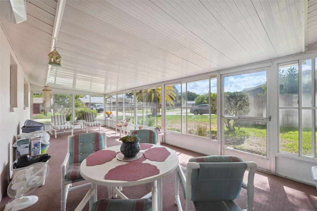 Large back porch with screens and plex windows.