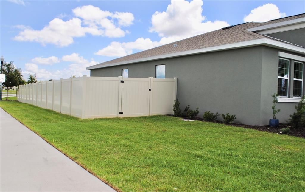 This property is completely fenced in with gates on both sides of the home.