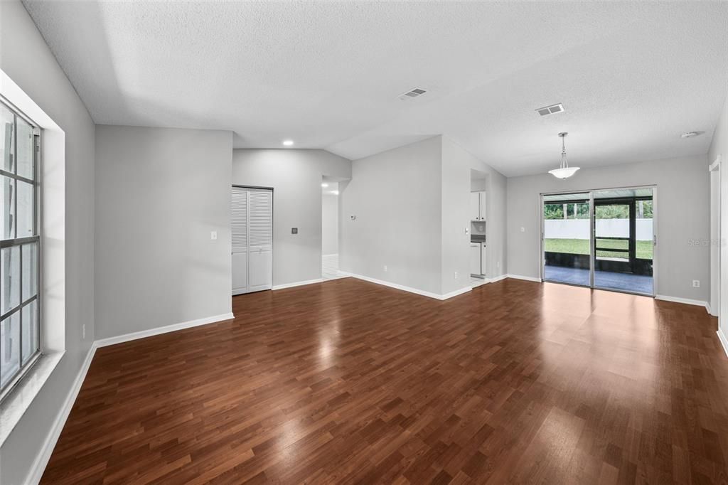 Formal Living room leading into the Dining room which the bright sunlight from large lanai