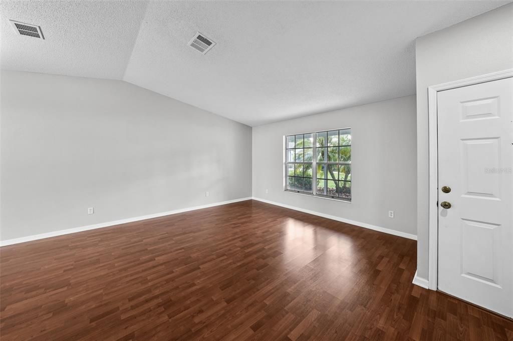 Formal Living room leading into the Dining room which the bright sunlight from large lanai