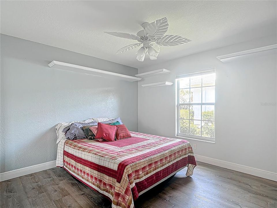 2nd bedroom with lots of shelves.