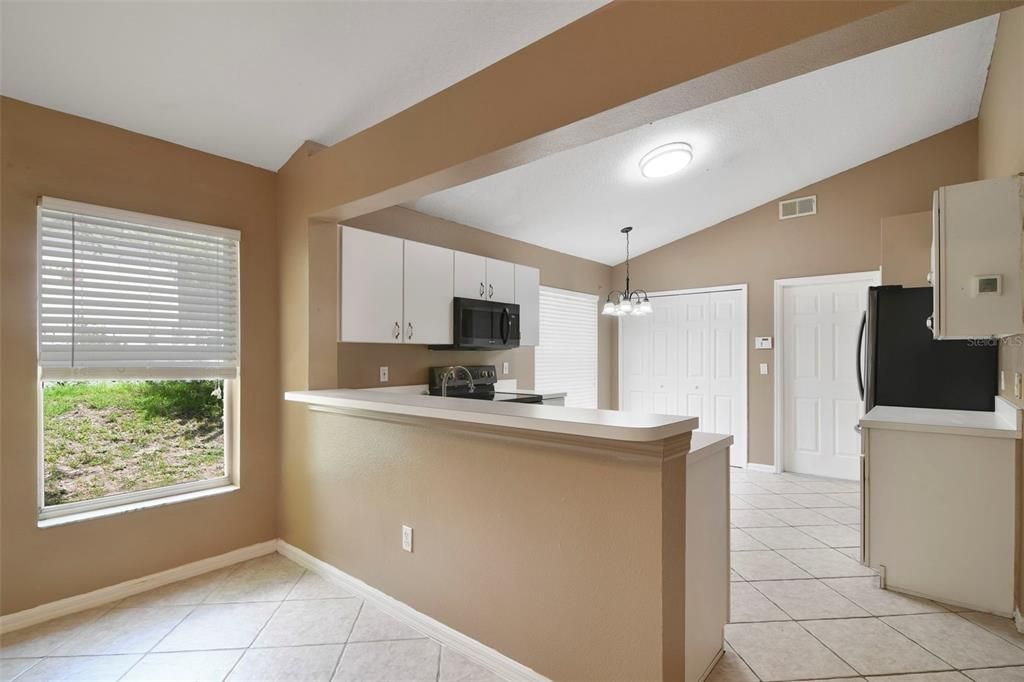 There are VAULTED CEILINGS in both areas as well as the EAT-IN KITCHEN offering the home chef a comfortable layout, pantry storage and a breakfast bar ideal for casual dining or entertaining connects it to the family room.