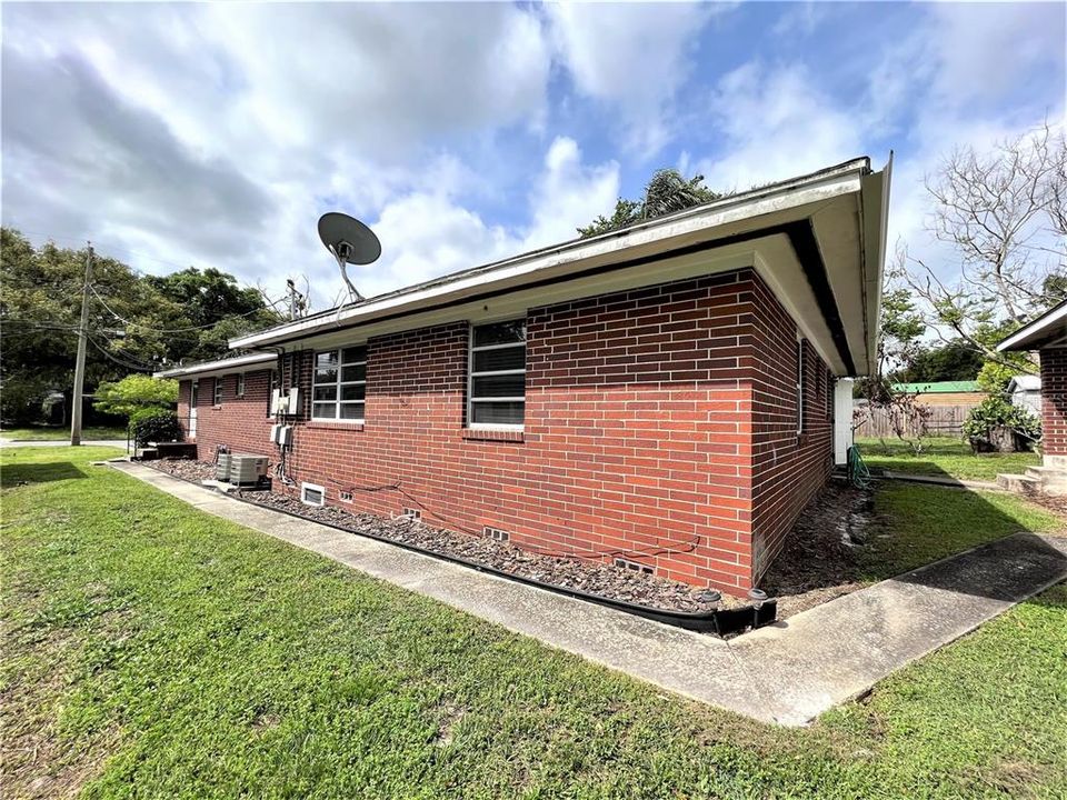 This unit also has a side door and sidewalk that lead to a covered rear carport with great storage and laundry room