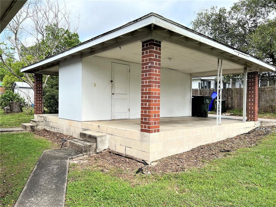 The covered carport, with storage room. This Duplex also has a rear alley entrance and extra parking in front of the home