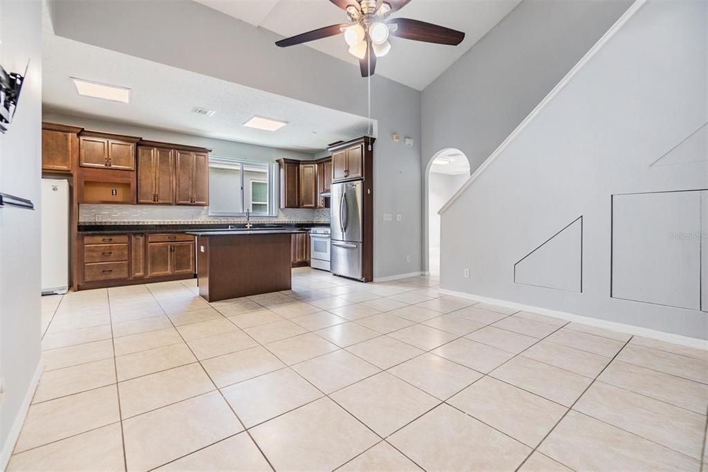 Inside kitchen and family room, vaulted ceilings, tile flooring and ceiling fan.