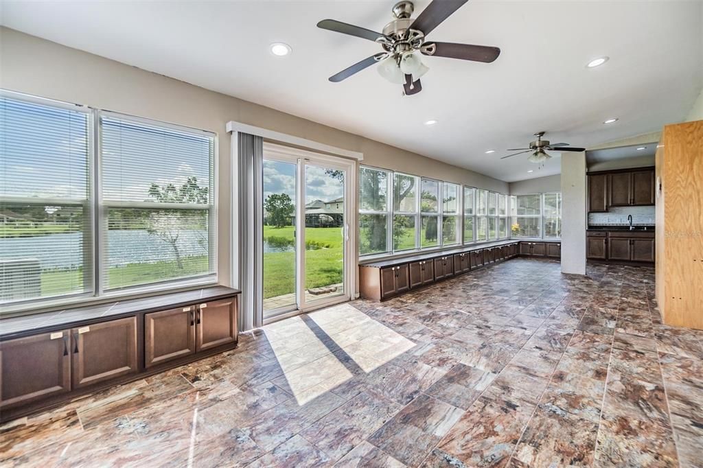 Huge Back patio with views of the water, ceiling fans, tile flooring, lots of storage and a full kitchen.