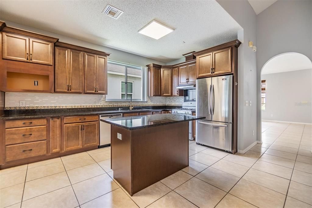 Inside kitchen, tile flooring and granite countertops.