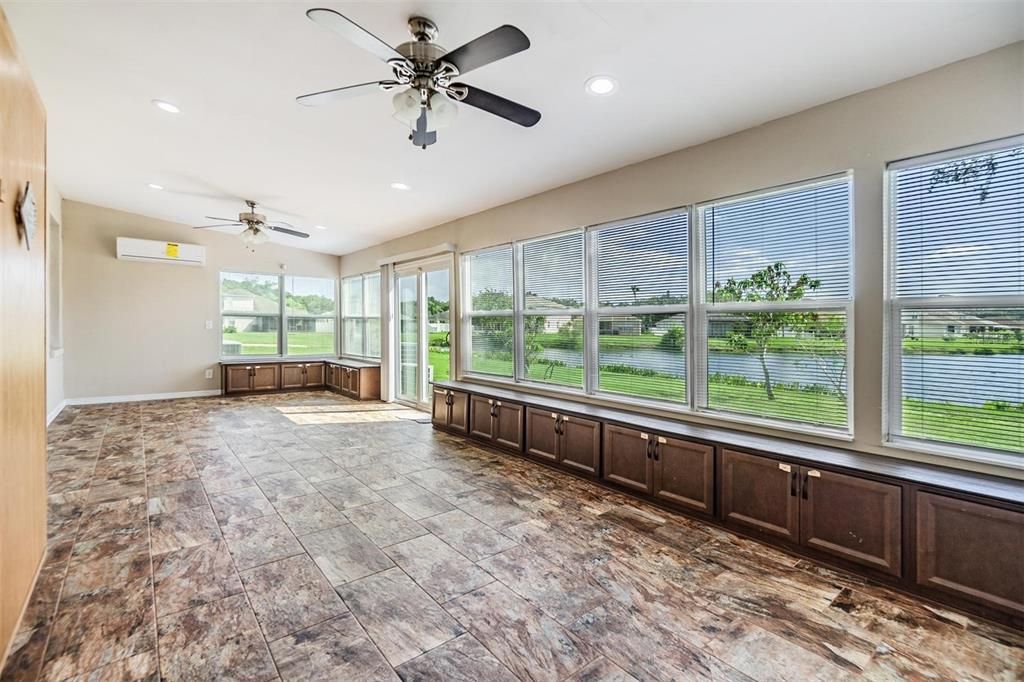 Huge Rear patio, tile flooring, views of the water, ceiling fans and an AC Spliter.