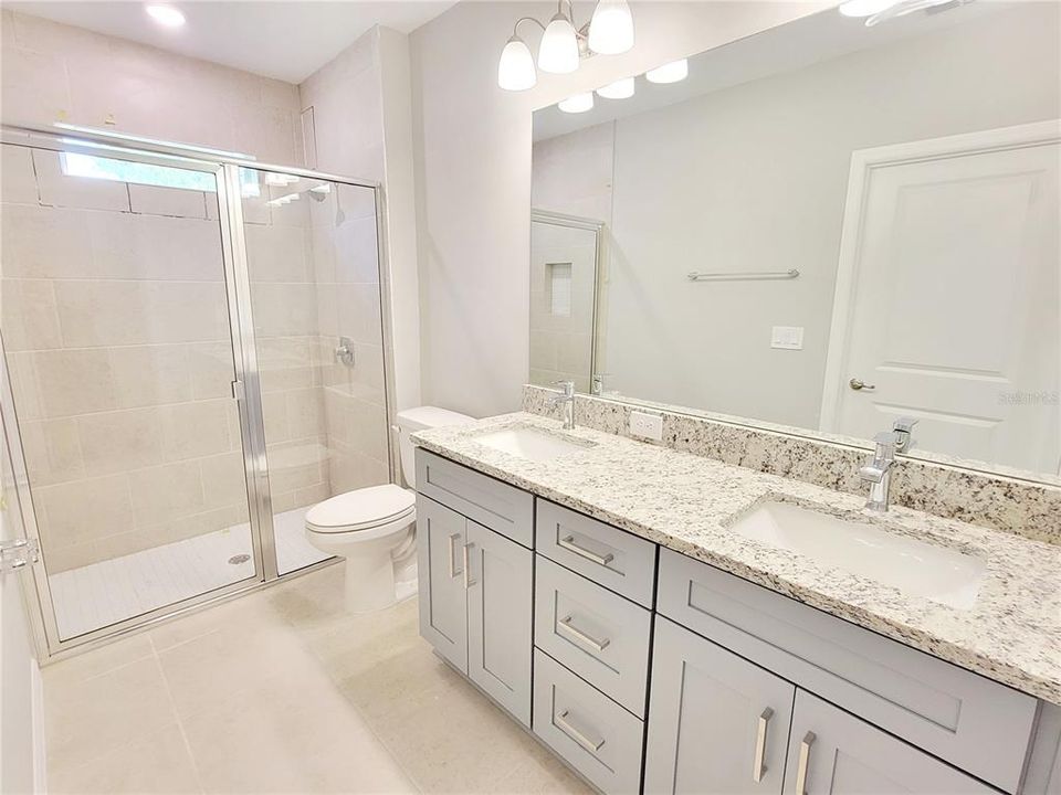 Primary bathroom with granite, dual sinks and large walk-in closet!