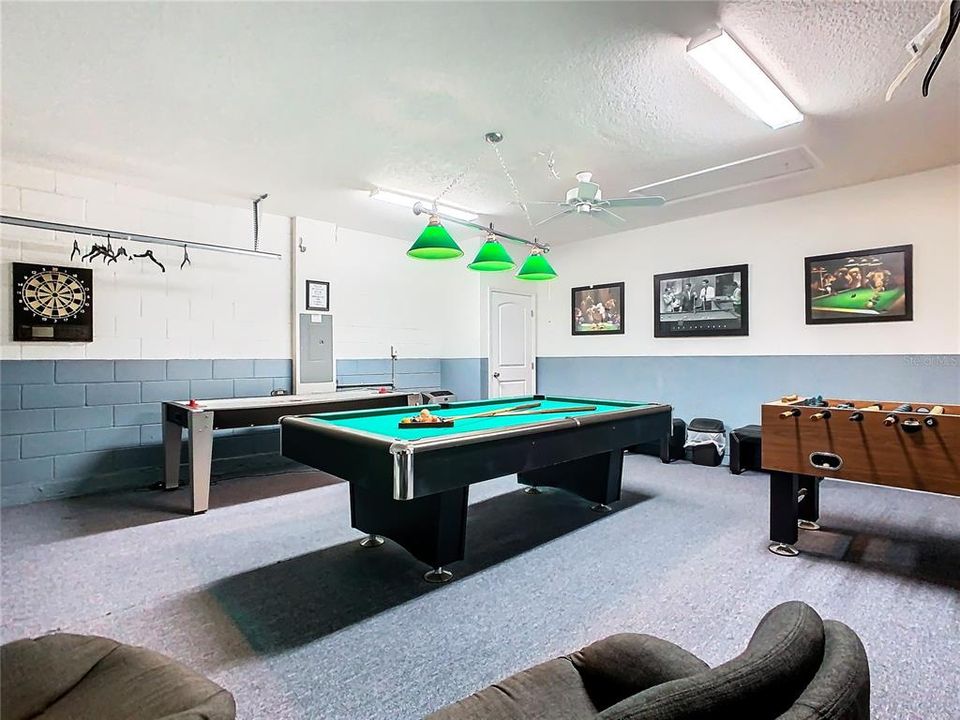 Well designed games room within garage complete with free standing AC unit ducting outside