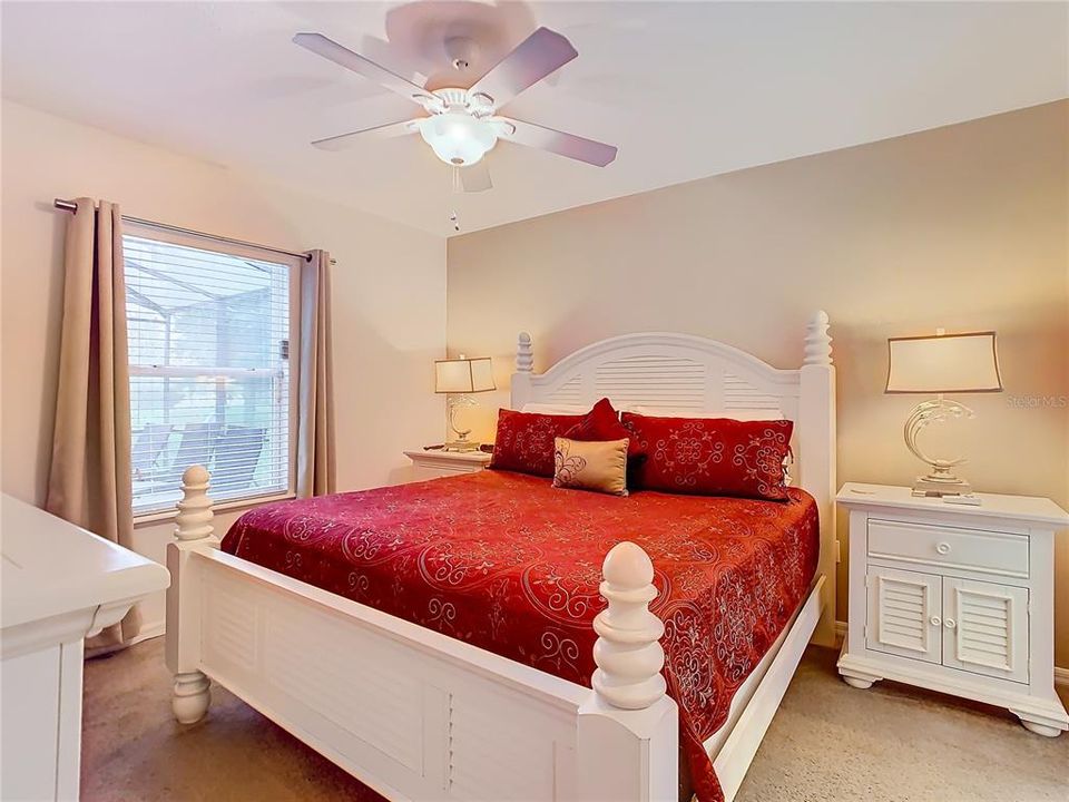 Spacious primary bedroom with walk-in closet overlooks your private pool area
