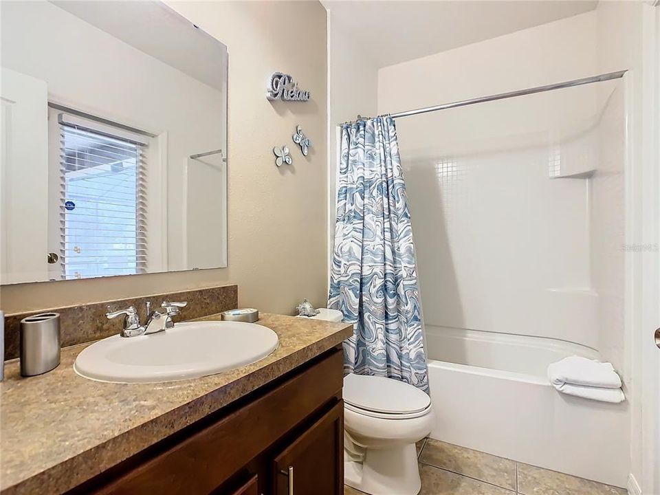Pool bathroom sits alongside bedrooms 4 and 5, and has easy access to the great room area.