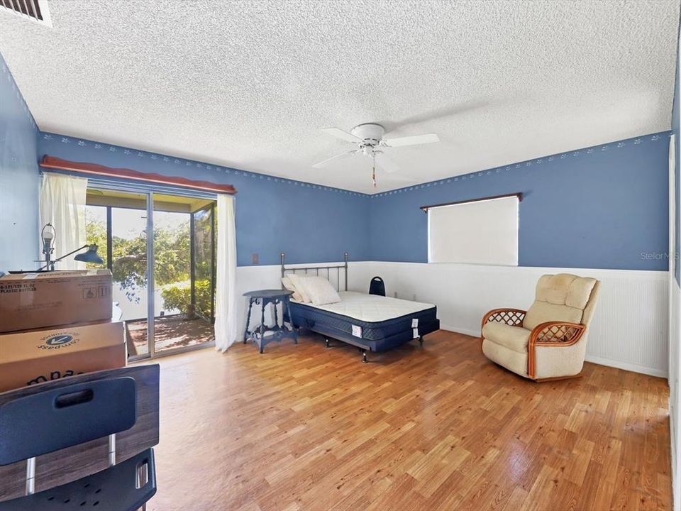 Primary Bedroom, Laminate flooring, sliders to Lanai