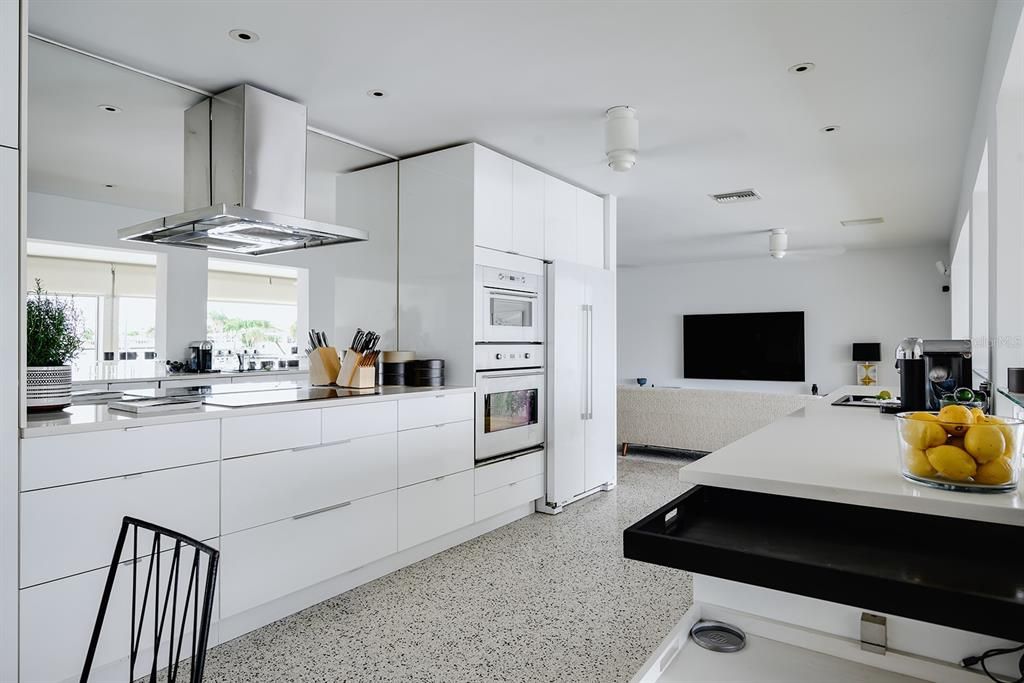 Modern kitchen with cooktop and double wall ovens.