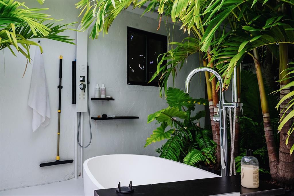 Primary bedroom outdoor shower and tub.