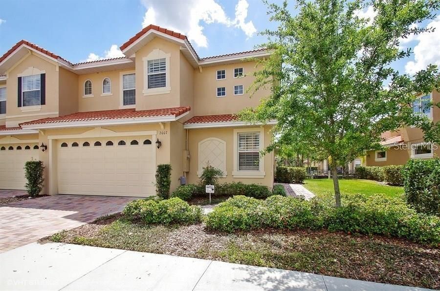 Exterior Front:  note pavered drive, tile roof, and corner/end unit.