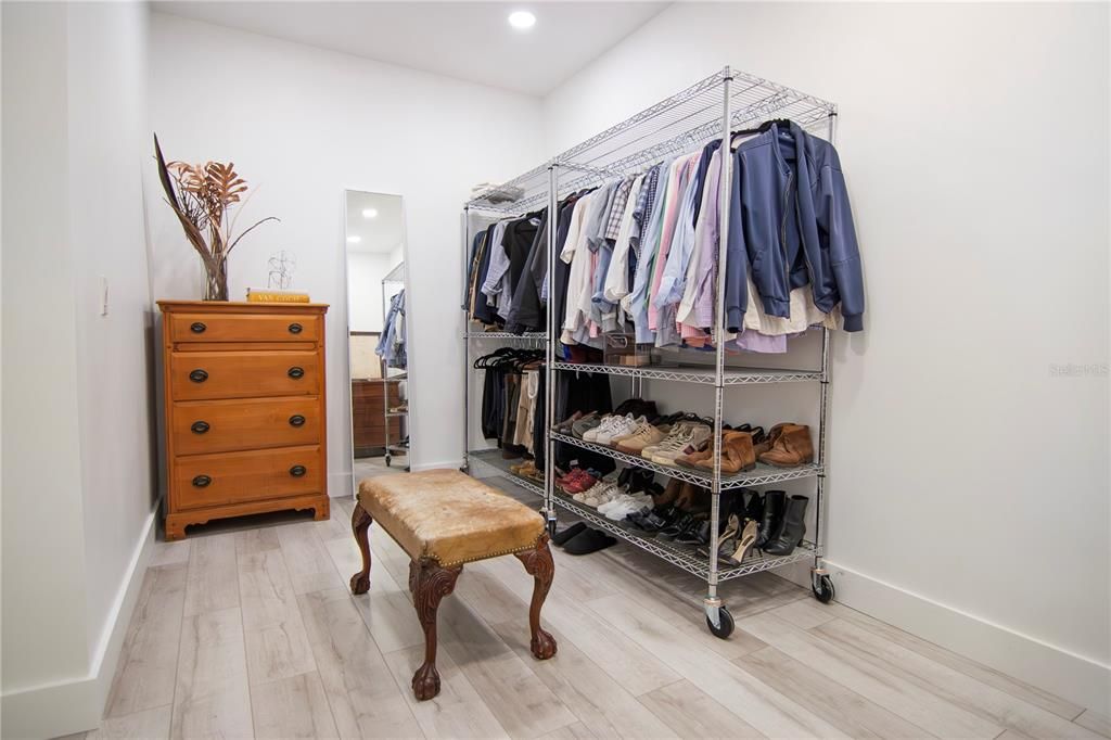 Spacious primary bedroom walk-in closet with pocket doors.