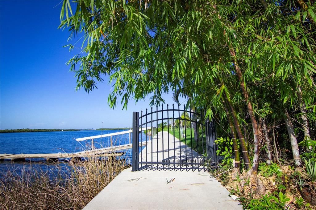 Aluminum pedestrian gate with lock at side of property