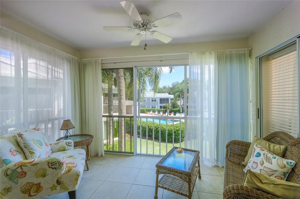 Enclosed lanai with a birds eye view of the pool.  Time to swim?