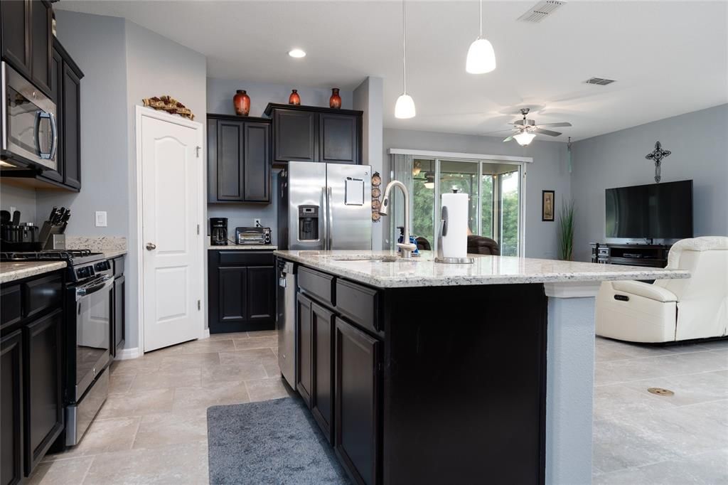 Spacious kitchen towards main living area and screened lanai