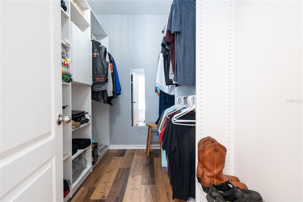 Huge ensuite walk-in closet with Closet By Design organizers.