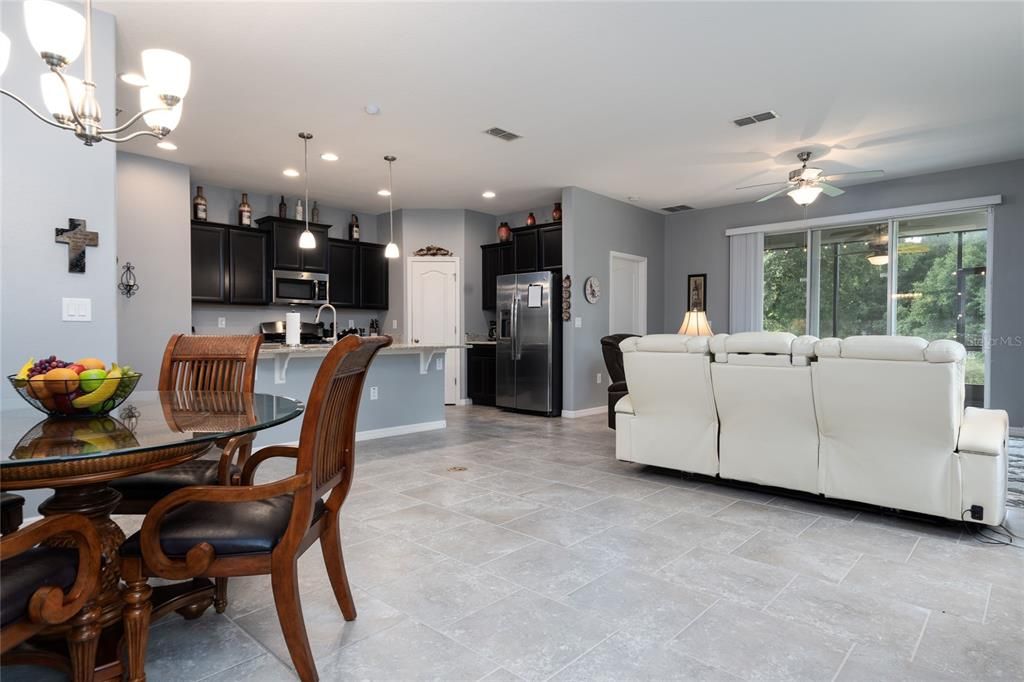 Dining area at left. Kitchen afar. Living area at right.