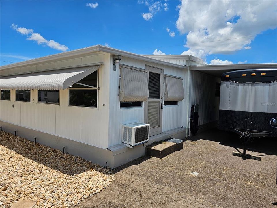 Front enclosed porch has a door that leads to outside