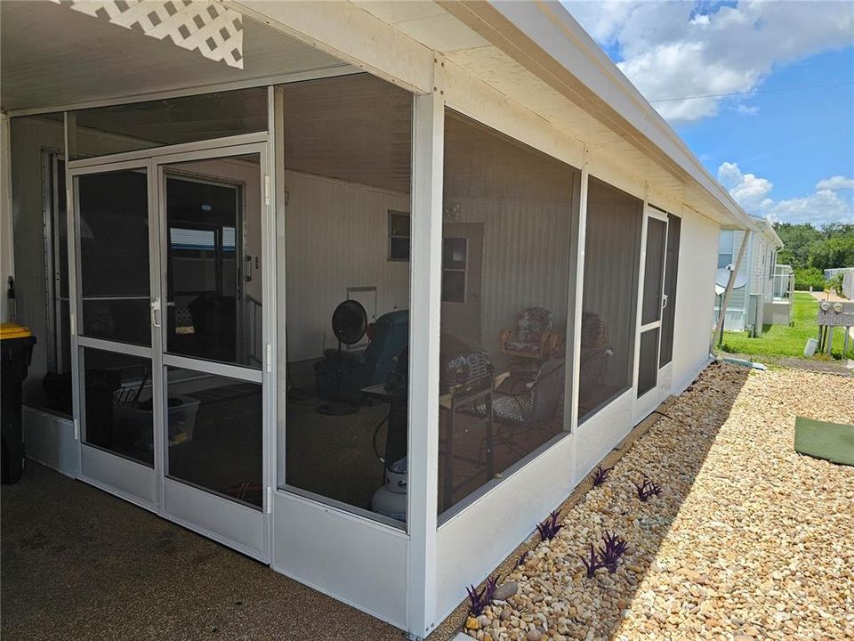 screened in porch with double doors which can open to accommodate large furniture or appliances