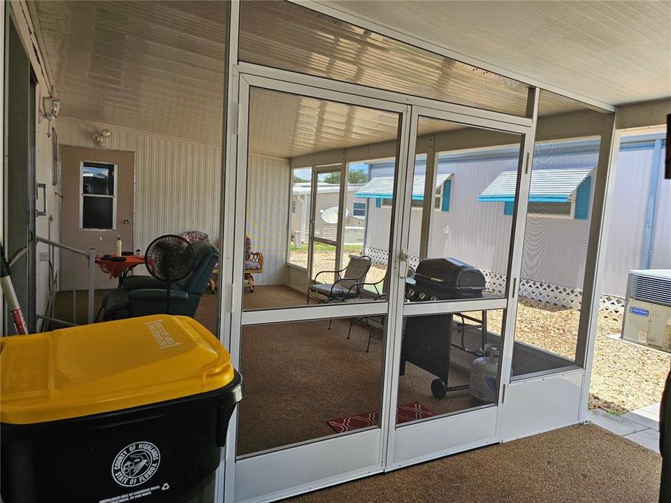 Double door open for easy access to the screened porch and there's another door facing south