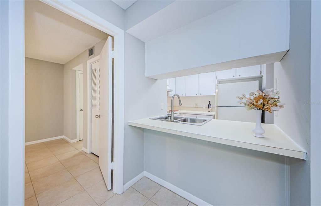 Breakfast Bar/ Door leads to the primary bedroom and bathroom