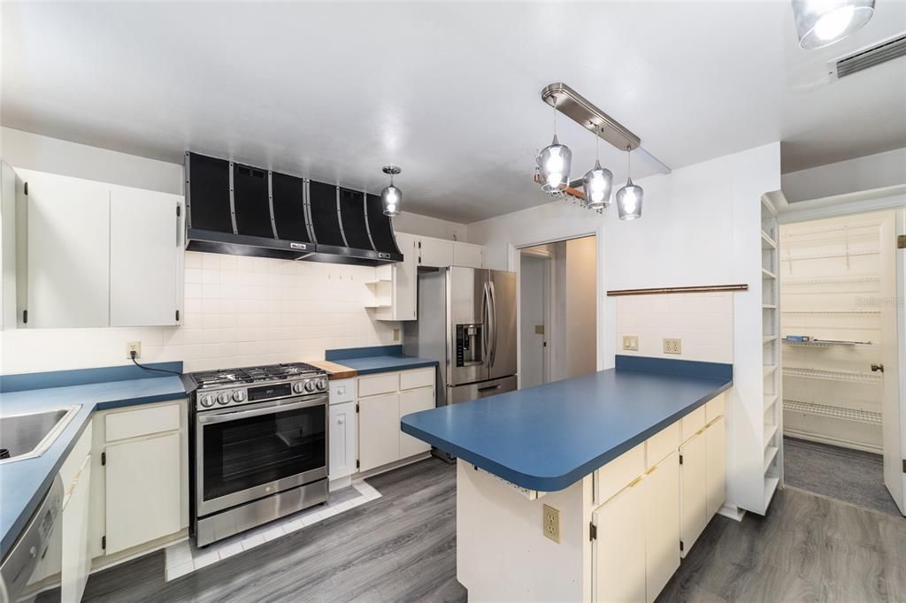 Kitchen with new Gas range with dual vents hoods