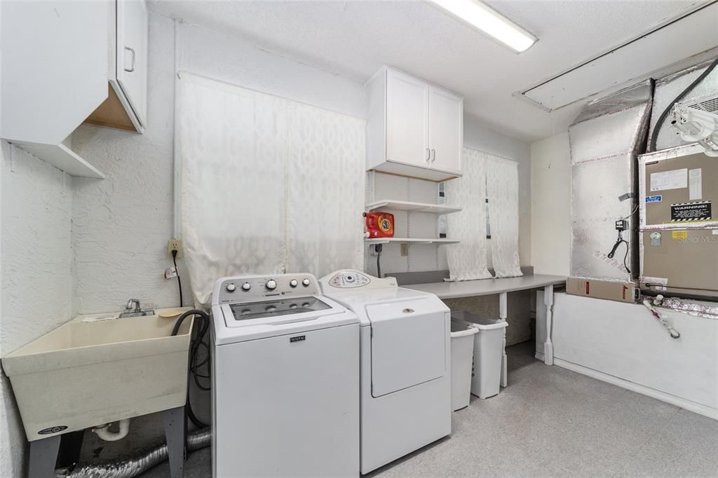 Large Laundry room with sink and Washer and Dryer stay