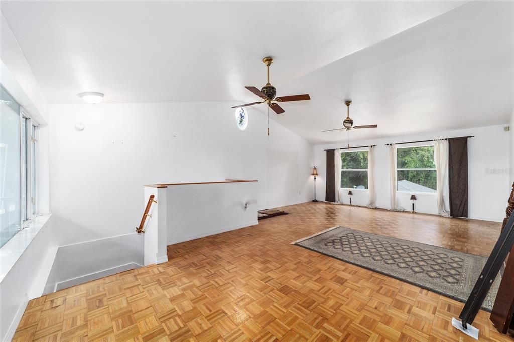 Large Master Bedroom with Parquet flooring