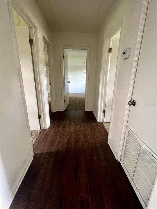 Hallway to the other three bedrooms and Bathroom