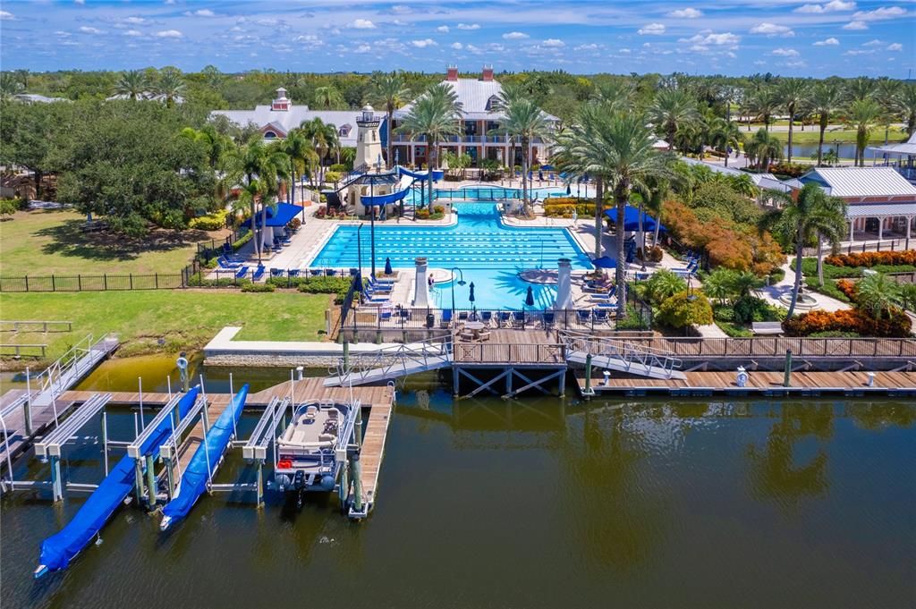 View of pool and club house of pools, water slide, community dock, short term boat tie up from the "bay"