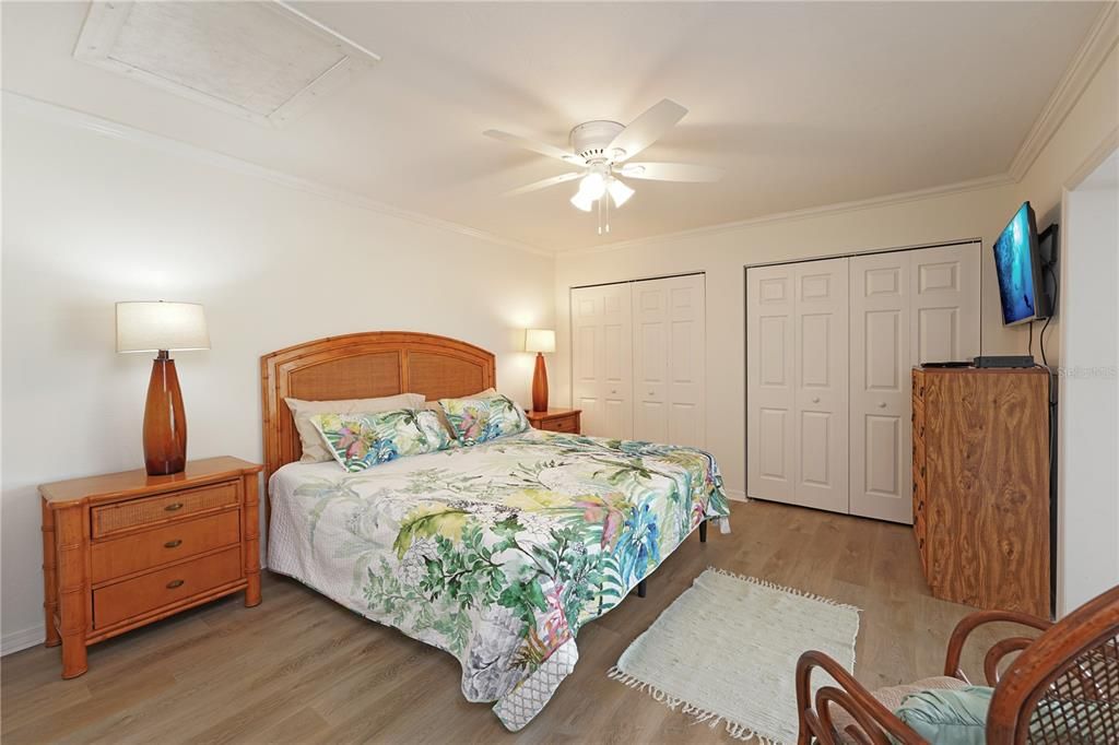 THE PRIMARY BEDROOM WITH LUXURY VINYL PLANK FLOORINGS