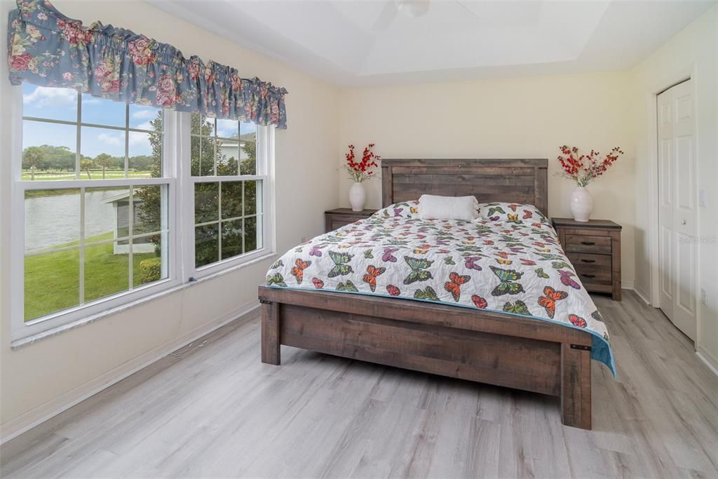 Large primary bedroom with water view.