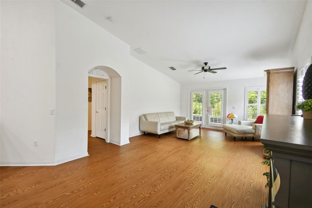 Vaulted ceilings and archway leading to Primary Suite