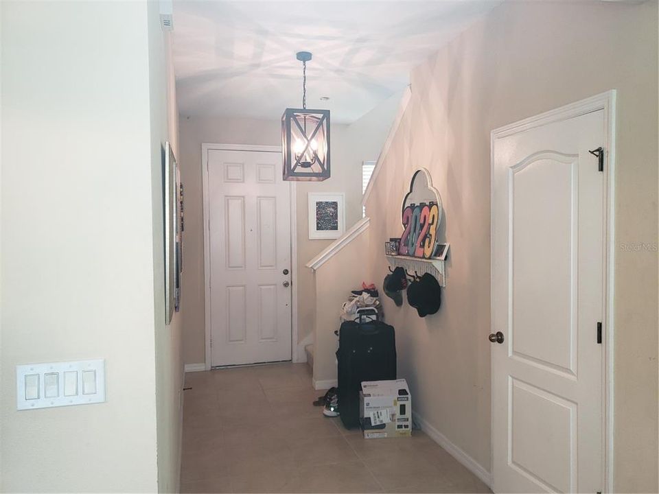 Standing in Livingroom looking toward Front Door and Stairs