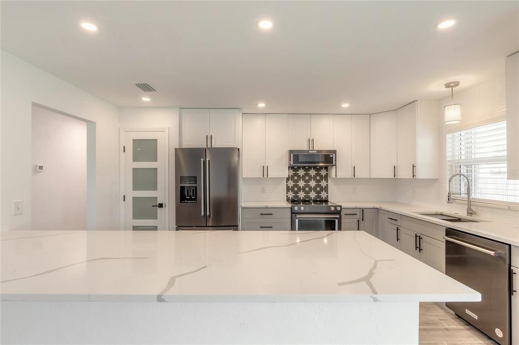 Stunning quartz countertops in this beautiful kitchen.