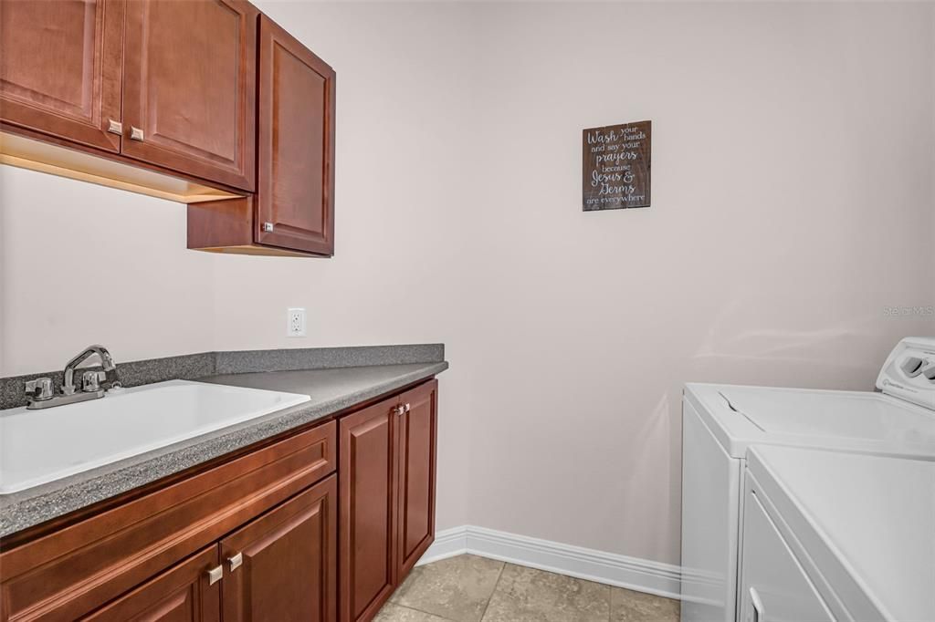 Laundry with Cabinetry and Sink