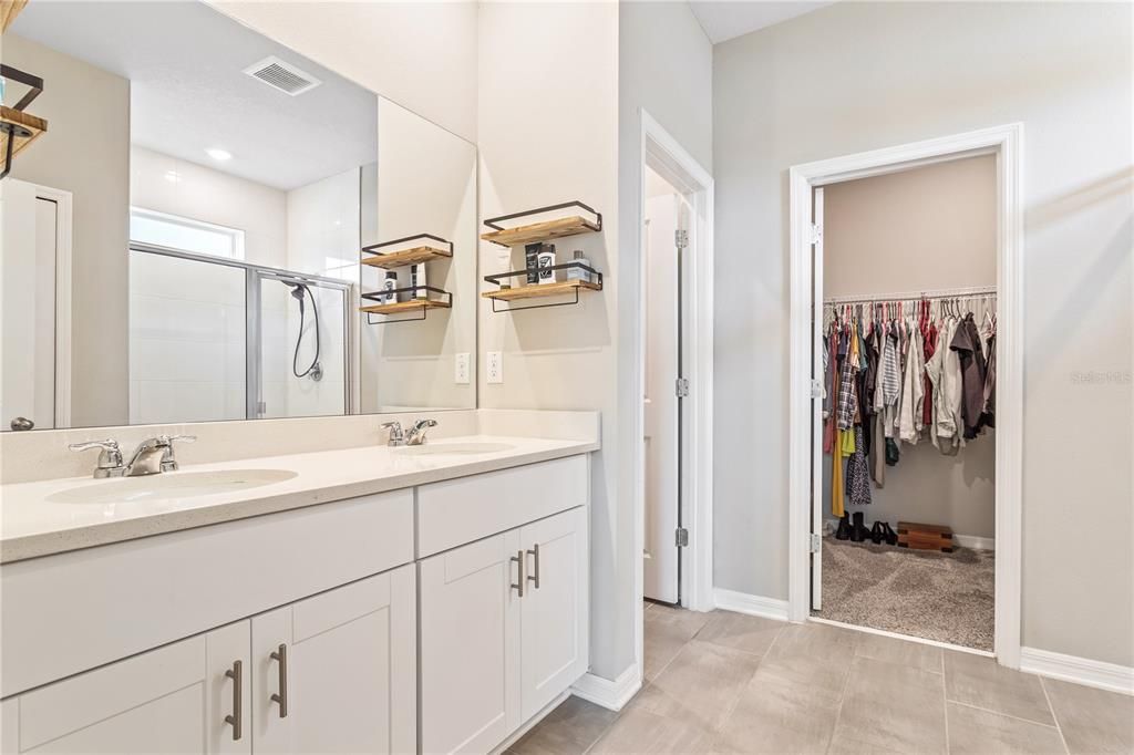 Ensuite to the primary with dual sinks, quartz countertops and water closet; walk in shower.